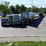 photo of wind turbine component being transported by truck