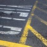 photo of yield painted on parking lot