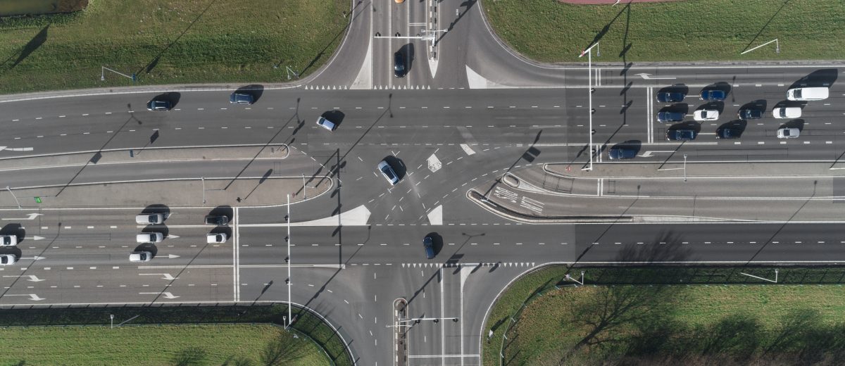 A Highway intersection with cars and traffic lights. Top view from drone