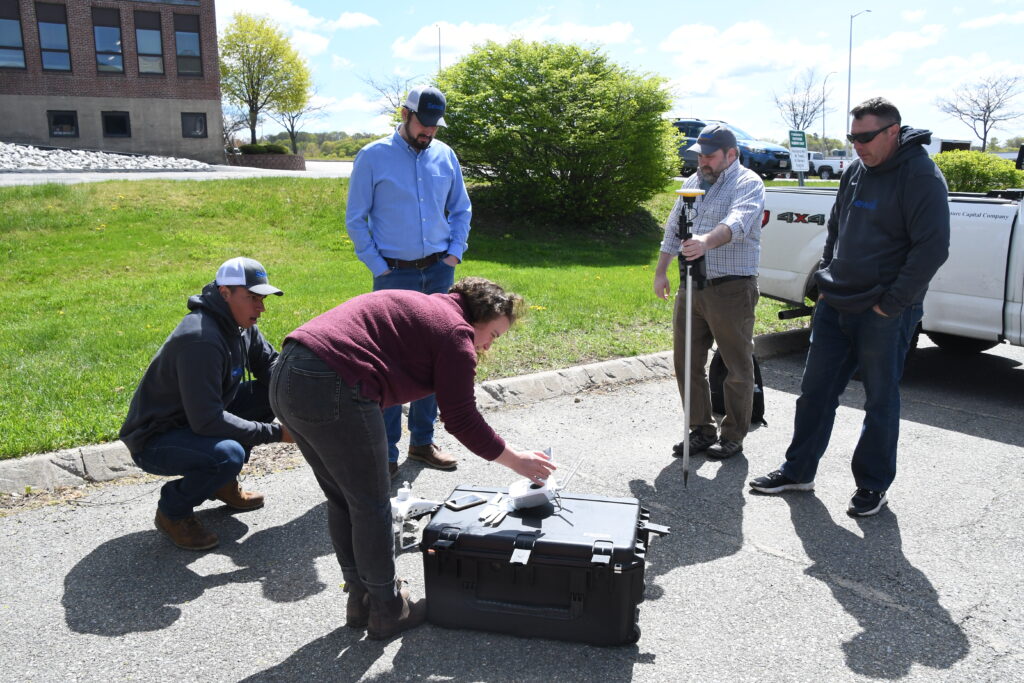Katie Moran (center) demonstrates drone calibration techniques to (L to R) Quinn Stamps, Marty Curnan, Justin Mugnai, and Brian Files